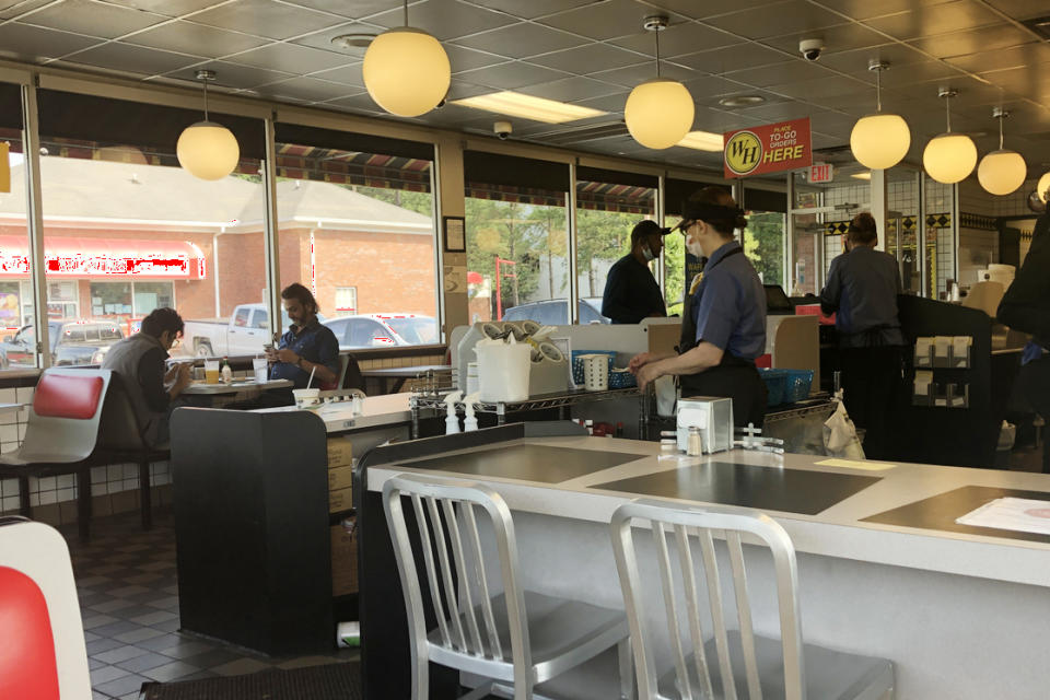 Customers sit inside a Waffle House Restaurant, Friday, May 22, 2020 in Atlanta. Vice President Mike Pence and Brian Kemp were scheduled to talk about reopening during the pandemic with members of the restaurant industry meeting at the headquarters of the popular Southern eatery, Waffle House. (Sudhin Thanawala)