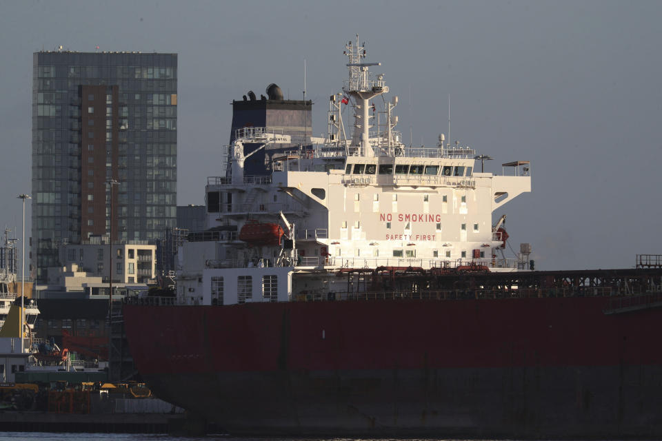 The Nave Andromeda oil tanker is docked next to the Queen Elizabeth II Cruise Terminal in Southampton, England, Monday, Oct. 26, 2020. The U.K. military seized control of the oil tanker that dropped anchor in the English Channel after reporting it had seven stowaways on board who had become violent. (Andrew Matthews/PA Wire via AP)