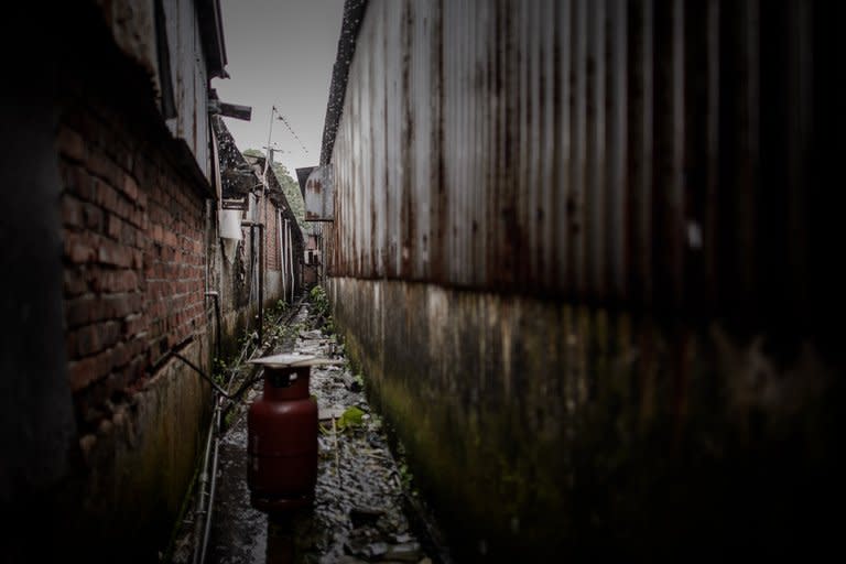 This picture taken on June 11, 2013 shows a gas cylinder outside a housing compound where asylum seekers from Bangladesh reside, in the Ping Che rural area of Hong Kong, near the border with mainland China. Hong Kong may be one of Asia's wealthiest hubs but the picture is very different for hundreds of asylum seekers forced into slum-like conditions as they scrape a living in the city