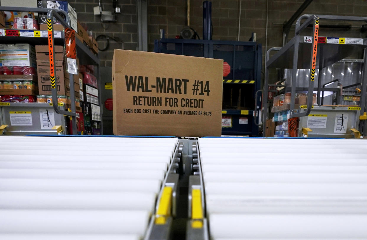 FILE - In this Nov. 9, 2018, file photo, a box of merchandise is unloaded from a truck and sent along a conveyor belt at a Walmart Supercenter in Houston. Walmart is rolling out an unlimited grocery delivery subscription service this fall for a $98 annual fee. The service will reach 1,400 stores in 200 markets and allows the nation’s largest grocer to further tap into time-starved shoppers looking for convenience. (AP Photo/David J. Phillip, File)