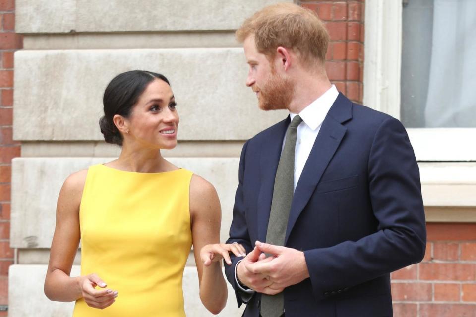 Meghan Markle chats animatedly to Prince Harry as they arrive at Marlborough House (PA)