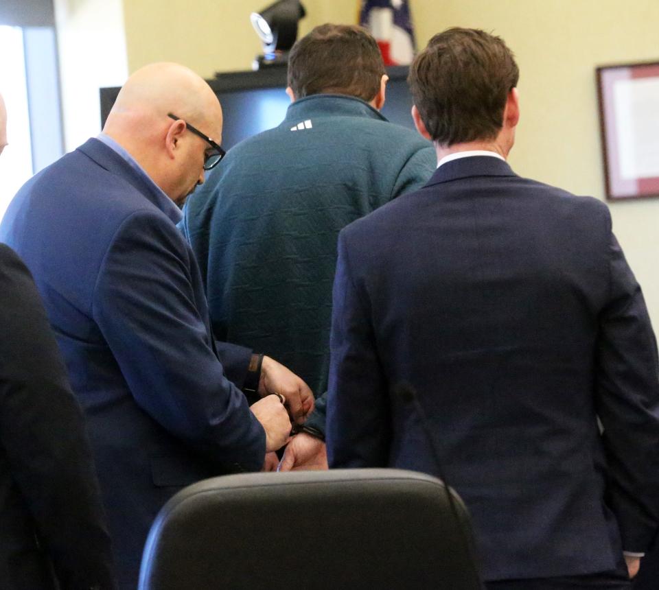 Timothy Verrill is handcuffed to be returned to jail after being found guilty of second-degree murder of two women at Strafford County Superior Court Wednesday, April 9, 2024.