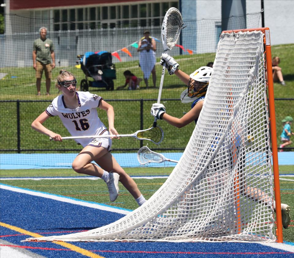 John Jay's Shannon Nolan maneuvers around the Queensbury goal during their girls lacrosse Class B state regional final at Hendrick Hudson High School in Montrose, June 4, 2022. 