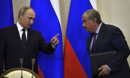 Russian President Vladimir Putin gestures as he talks with Igor Sechin, the chief executive of Russia's top oil producer Rosneft, during a signing ceremony following a meeting with Italian Prime Minister Paolo Gentiloni at the Bocharov Ruchei state residence in Sochi, Russia, May 17, 2017. REUTERS/Yuri Kadobnov/Pool/Files