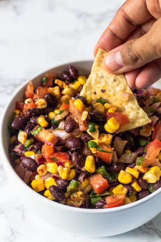 <p>Spice Up The Curry</p><p>Black bean and corn salsa is one of my favorite appetizers/snacks and it’s always a crowd favorite! It has such a deliciously fresh and vibrant flavor with just a perfect blend of ingredients. It is the perfect refreshing dip or topping.</p><p><strong>Get the Recipe: </strong><a href="https://www.spiceupthecurry.com/black-bean-corn-salsa/" rel="nofollow noopener" target="_blank" data-ylk="slk:Black Bean and Corn Salsa;elm:context_link;itc:0;sec:content-canvas" class="link "><strong>Black Bean and Corn Salsa</strong></a></p>