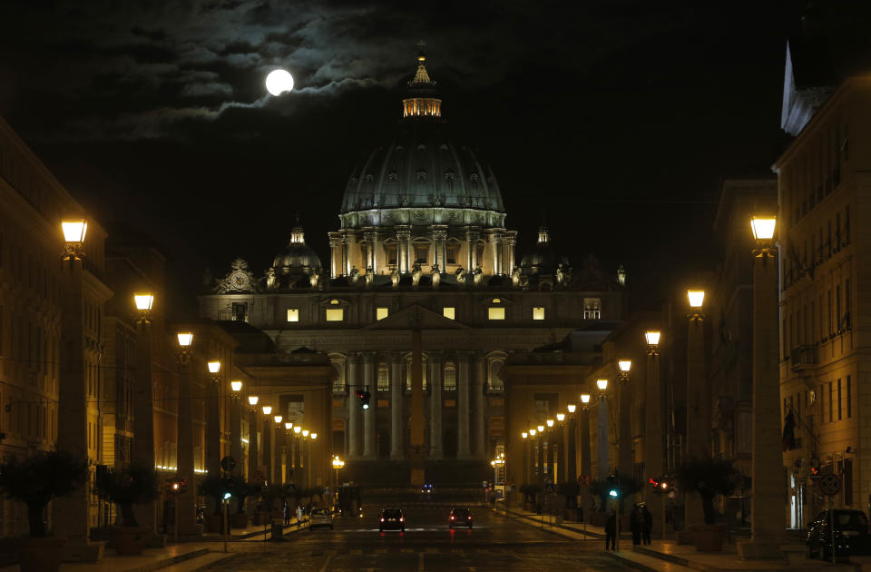 FILE - The fool moon is seen above the St. Peter's Basilica at the Vatican, on Feb. 26, 2013. Pope Gregory XIII, the 16th century pontiff responsible for what is today known as the Gregorian calendar, now has another, celestial claim to fame. A working group of the International Astronomical Union has named an asteroid after him, the Vatican Observatory said Tuesday, Feb. 28, 2023. The "560974 Ugoboncompagni" (Gregory's birthname was Ugo Boncompagni) was announced in the Feb. 27 update of the union's Working Group for Small Bodies Nomenclature. (AP Photo/Dmitry Lovetsky, File)