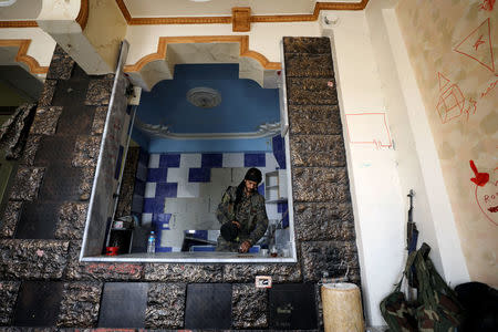 A fighter from Syrian Democratic Force is seen makes tea inside a house in Raqqa. REUTERS/Rodi Said