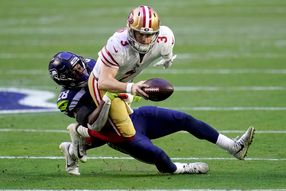 San Francisco 49ers quarterback C.J. Beathard (3) is sacked by Seattle Seahawks safety Ugo Amadi (28) during the first half of an NFL football game, Sunday, Jan. 3, 2021, in Glendale, Ariz. (AP Photo/Ross D. Franklin)
