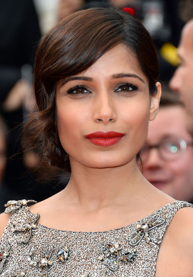 Cannes Film Festival 2013: Freida Pinto worked the <a href="http://uk.lifestyle.yahoo.com/photos/celebrities-metallic-fashion-trend-clothes-outfit-style-slideshow/" data-ylk="slk:red lipstick trend;elm:context_link;itc:0;sec:content-canvas;outcm:mb_qualified_link;_E:mb_qualified_link;ct:story;" class="link  yahoo-link">red lipstick trend</a> on the red carpet.