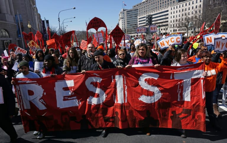 Health care activists march to the Trump International hotel during a protest on March 23, 2017 in Washington, DC