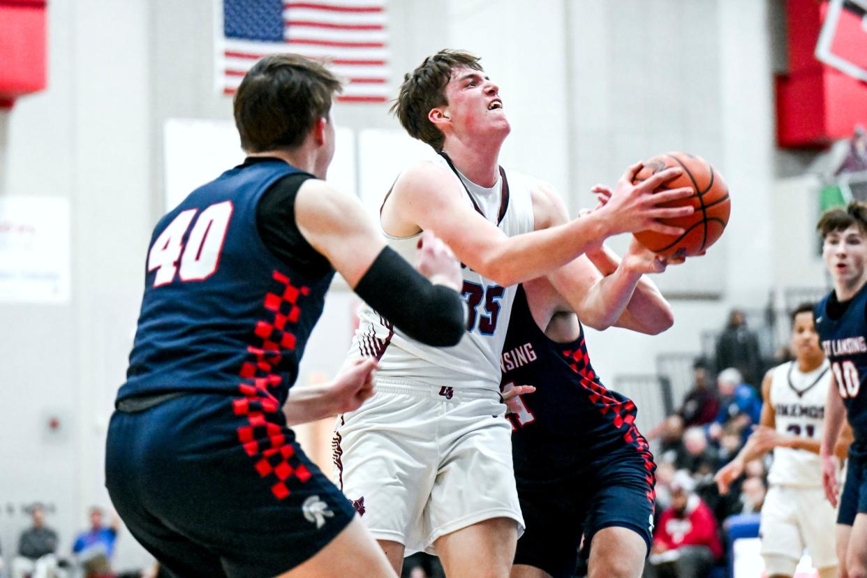 Okemos' Brennan Walton scores against East Lansing during the second quarter on Friday, March 1, 2024, at Mason High School.