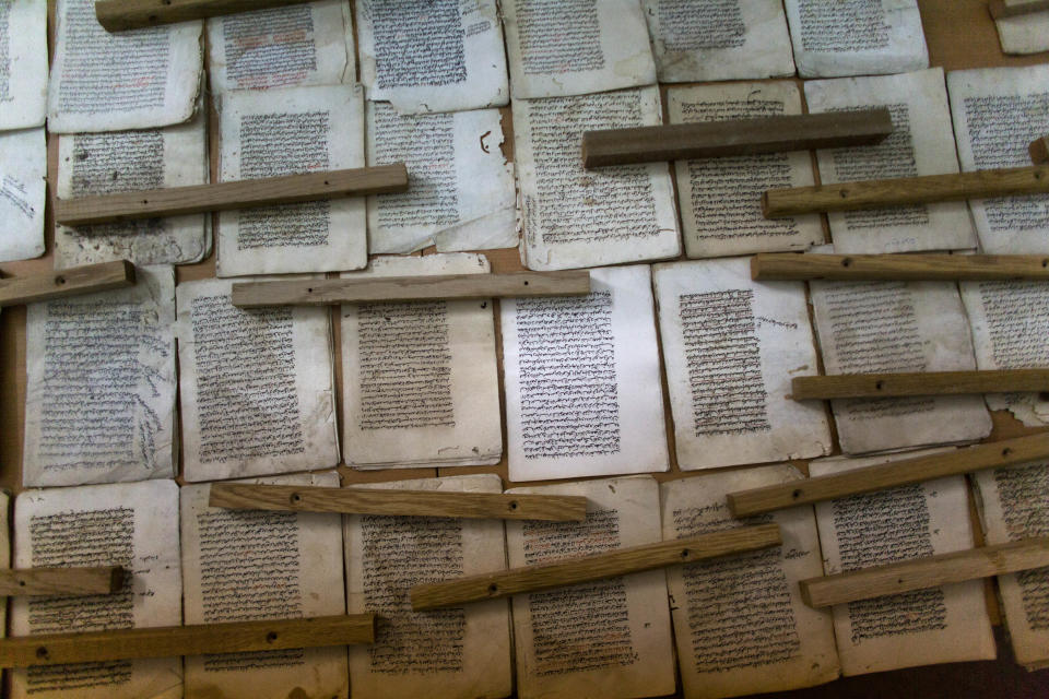 In this photo taken on Monday, Jan. 27, 2014, old manuscripts are laid out at the al-Aqsa mosque compound library in Jerusalem. The library has a collection of some 4,000 old manuscripts with about a quarter considered in poor condition. Half of the books are already undergoing restoration funded by the Waqf, Jordan’s Islamic authority which manages the holy site, and with assistance from UNESCO. (AP Photo/Dusan Vranic)