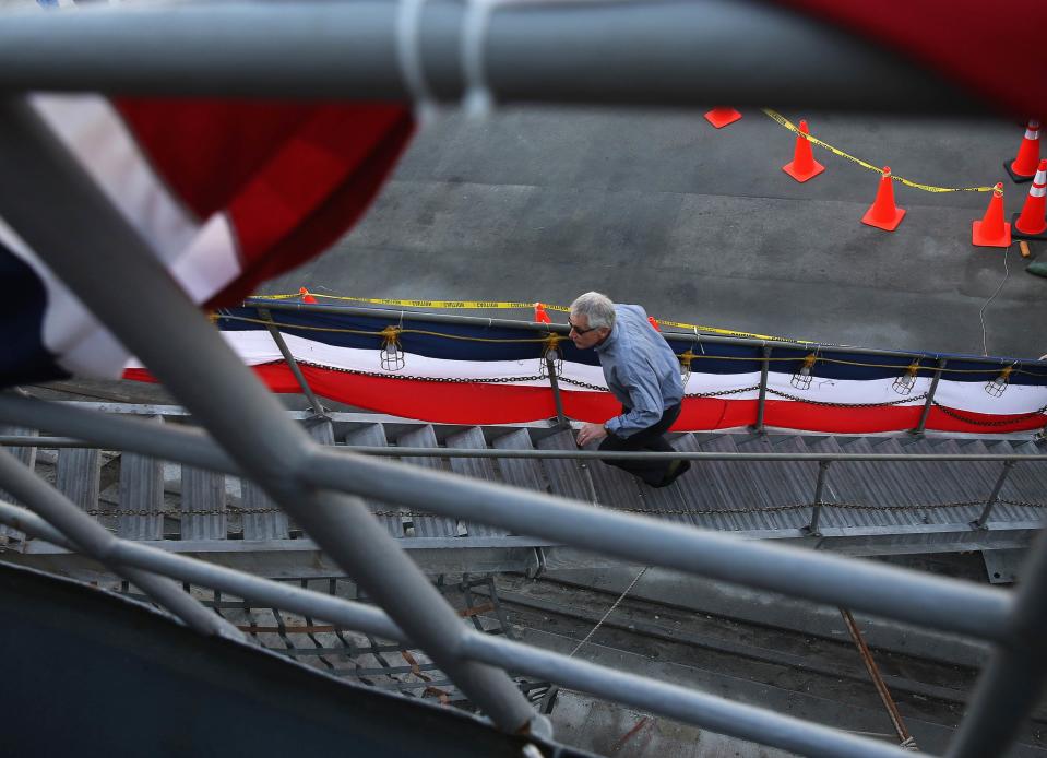 U.S. Secretary of Defense Chuck Hagel walks up the stairs of the USS Ponce during a tour, in Manama