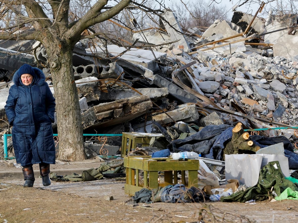 A military uniform is visible amid debris of a destroyed building purported to be used as a temporary accommodation for Russian soldiers, dozens of whom were killed in a Ukrainian missile strike in Makiivka, Russian-controlled Ukraine, Jan. 10, 2023.  (Alexander Ermochenko/Reuters - image credit)