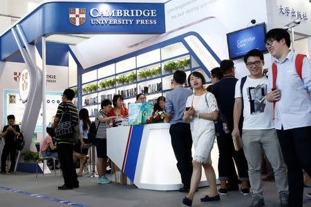 People walk past the Cambridge University Press (CUP) stall at the Beijing International Book Fair in Beijing, China, August 23, 2017. REUTERS/Thomas Peter