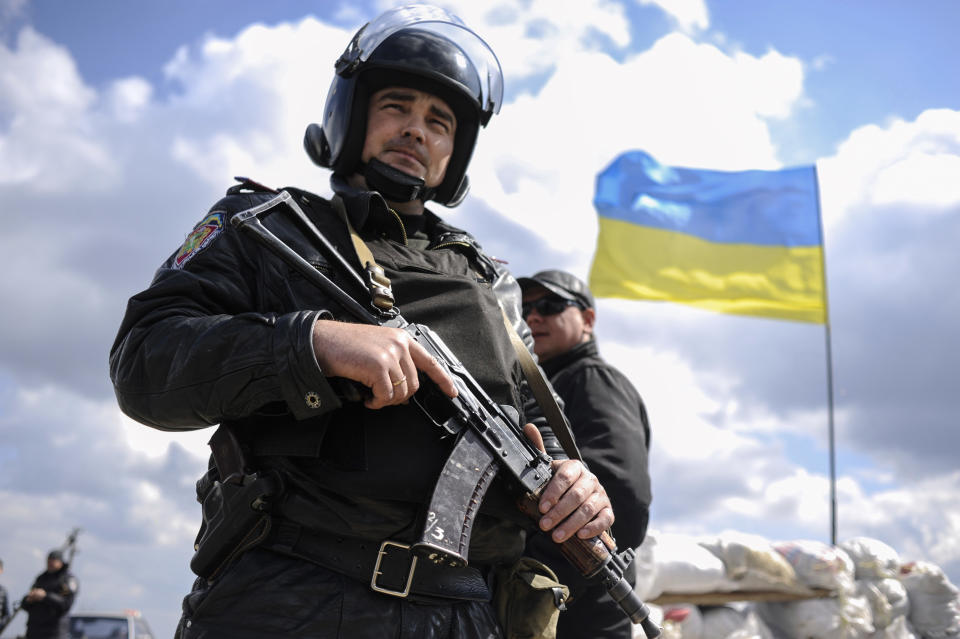 In this photo taken on Tuesday, April 15, 2014, a Ukrainian guards a check-point near Barvinkove, eastern Ukraine. In the first Ukrainian military action against a pro-Russian uprising in the east, government forces repelled an attack Tuesday by about 30 gunmen at an airport, beginning what the president called an "anti-terrorist operation" to try to restore authority over the restive region. (AP Photo/Evgeniy Maloletka)