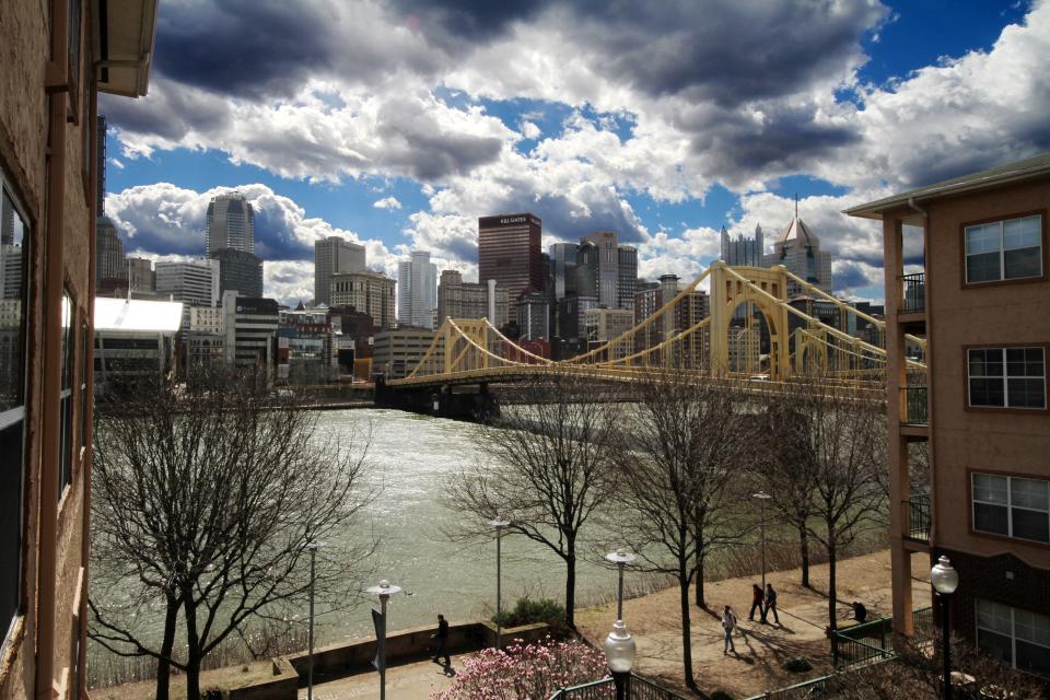 Clouds hang over the skyline of downtown Pittsburgh, the Rachel Carson Bridge, and the Allegheny River on Friday, March 18, 2016.