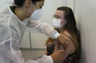 A military nurse administers the Pfizer coronavirus vaccine at a vaccination center in Lisbon, Tuesday, Sept. 21, 2021. Portugal's goal of fully vaccinating 85% of the population against COVID-19 may be just a week away. (AP Photo/Armando Franca)