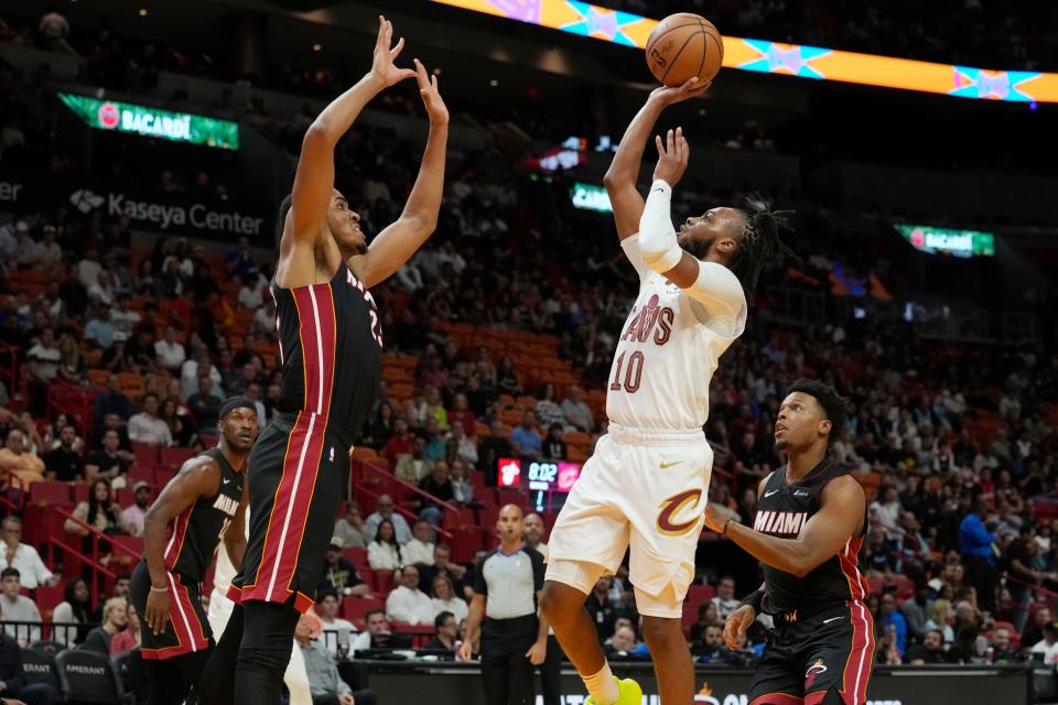Cleveland Cavaliers guard Darius Garland (10) aims to score as Miami Heat center Orlando Robinson (25) defends during the first half of an NBA basketball game, Friday, Dec. 8, 2023, in Miami. (AP Photo/Marta Lavandier)