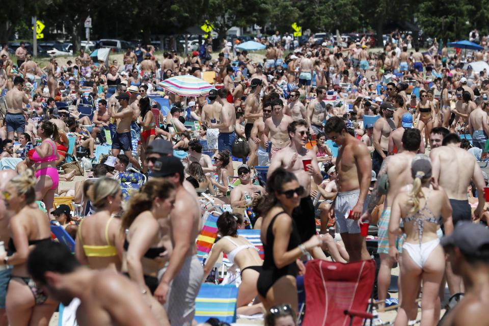 Crowds gather on L Street Beach, Saturday, June 5, 2021, in the South Boston neighborhood of Boston. New England is giving the rest of the country a possible glimpse into the future if more Americans get vaccinated. The six-state region has among the highest vaccination rates in the U.S. and is seeing sustained drops in COVID-19 cases, hospitalizations and deaths. (AP Photo/Michael Dwyer)