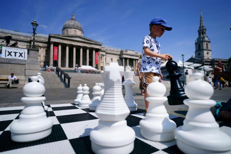 Finn Moriarty, five, moves giant chess pieces during ChessFest (Victoria Jones/PA) (PA Wire)