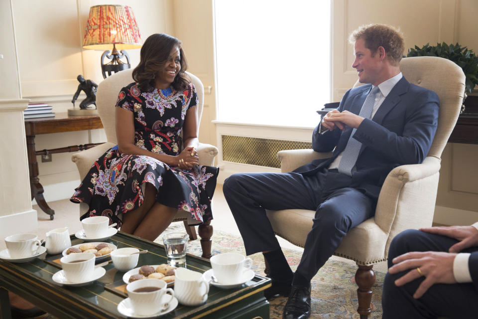 LONDON, ENGLAND - JUNE 16:  In this handout photo provided by The White House, US First Lady Michelle Obama meets Prince Harry at Kensington Palace on June 16, 2015 in London, England. The US First Lady is travelling with her daughters, Malia and Sasha and her mother, Mrs. Marian Robinson, to continue a global tour promoting her 'Let Girls Learn Initiative'. The event at the school was to discuss how the UK and USA are working together to expand girl's education around the world. (Photo by Amanda Lucidon/The White House via Getty Images)