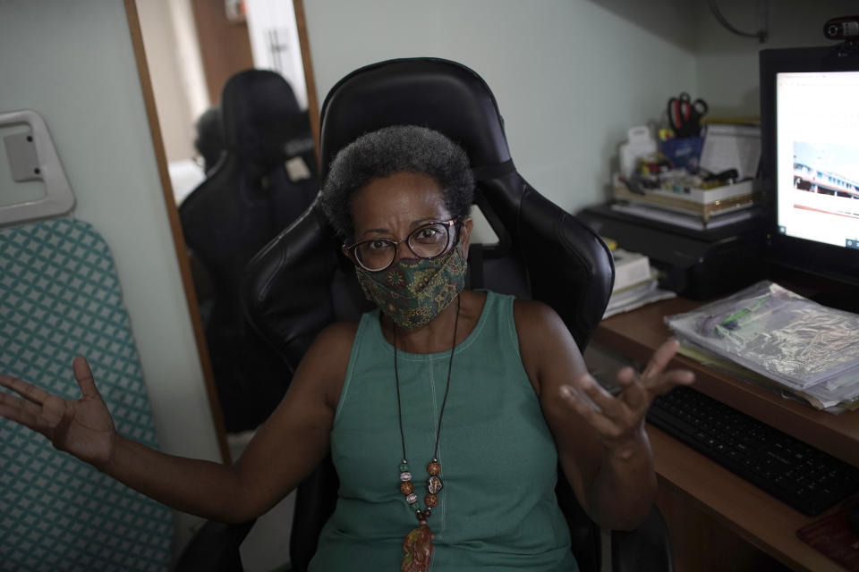 Dr. Regina Flauzino speaks during an interview in her home in Rio de Janeiro, Brazil, Friday, Jan. 15, 2021. Like many Brazilian public health experts, Flauzino spent most of 2020 watching with horror as COVID-19 devastated Brazil. (AP Photo/Silvia Izquierdo)