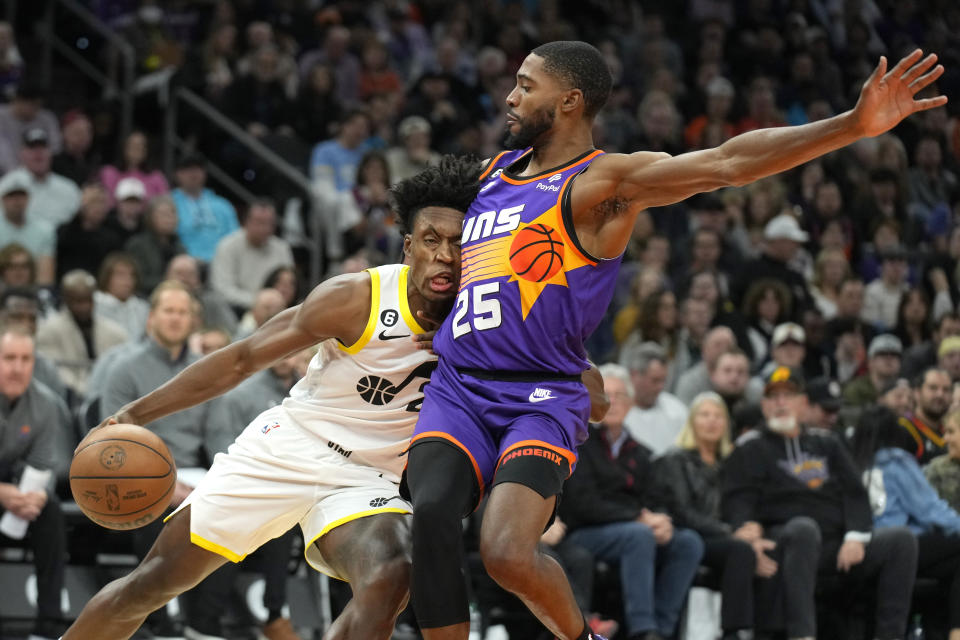 Utah Jazz guard Collin Sexton drives on Phoenix Suns forward Mikal Bridges (25) during the first half of an NBA basketball game, Saturday, Nov. 26, 2022, in Phoenix. (AP Photo/Rick Scuteri)