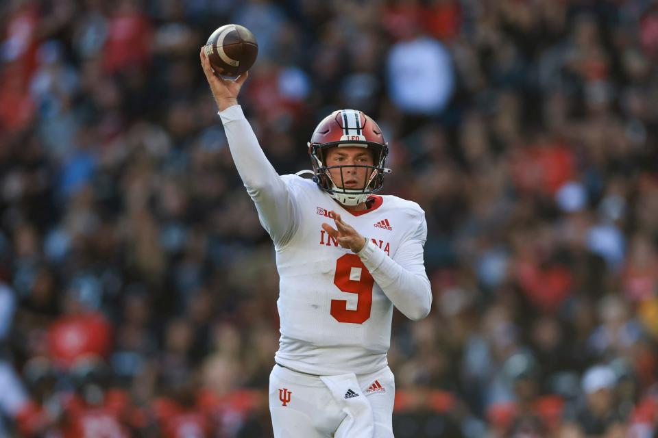 Indiana quarterback Connor Bazelak throws a touchdown to running back Shaun Shivers during the second half of an NCAA college football game against Cincinnati, Saturday, Sept. 24, 2022, in Cincinnati. Cincinnati won 45-24. (AP Photo/Aaron Doster)