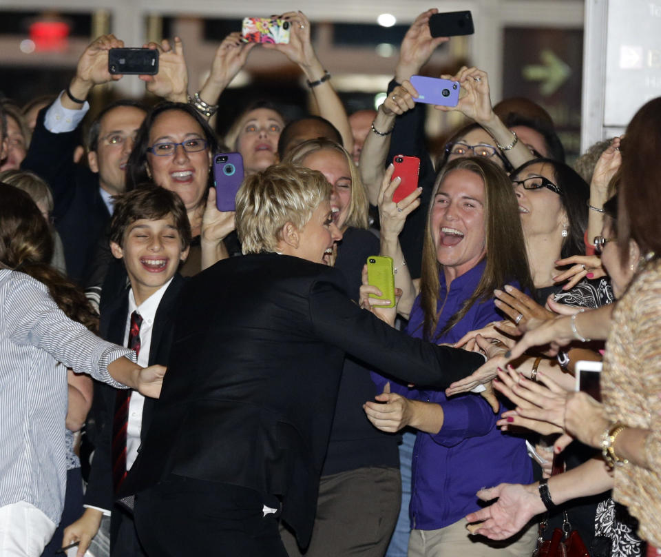 Entertainer Ellen DeGeneres, center, greets fans on the red carpet before receiving the 15th annual Mark Twain Prize for American Humor at the Kennedy Center, Monday, Oct. 22, 2012, in Washington. (AP Photo/Alex Brandon)