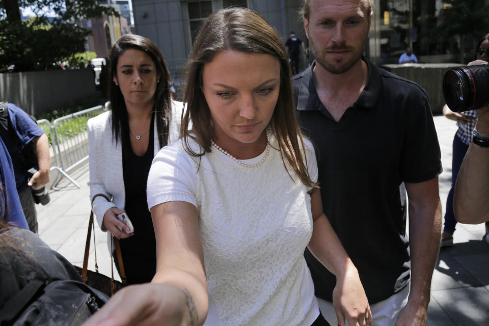 Courtney Wild, center, an accuser of Jeffery Epstein, leaves the courthouse in New York, Monday, July 15, 2019. Financier Jeffrey Epstein will remain behind bars for now as a federal judge mulls whether to grant bail on charges he sexually abused underage girls. (AP Photo/Seth Wenig)