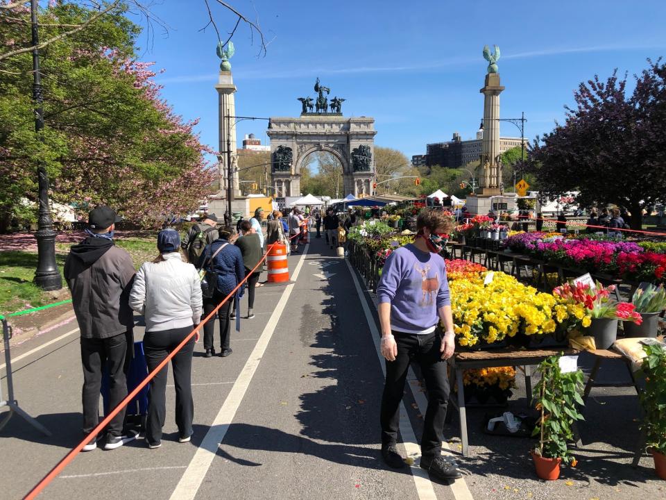 Shoppers wait on one of several lines to make purchases at the farmer’s market at Grand Army Plaza in Brooklyn on Saturday, May 2, 2020. As warmer temperatures tempted New Yorkers to come out of quarantine due to coronavirus, police dispatched 1,000 officers this weekend to enforce social distancing and a ban on congregating in public spaces. (AP Photo/Peter Morgan)