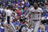 Arizona Diamondbacks' Geraldo Perdomo, right, celebrates with Ketel Marte after he scored during the seventh inning of a baseball game against the Chicago Cubs in Chicago, Sunday, May 22, 2022. (AP Photo/Nam Y. Huh)