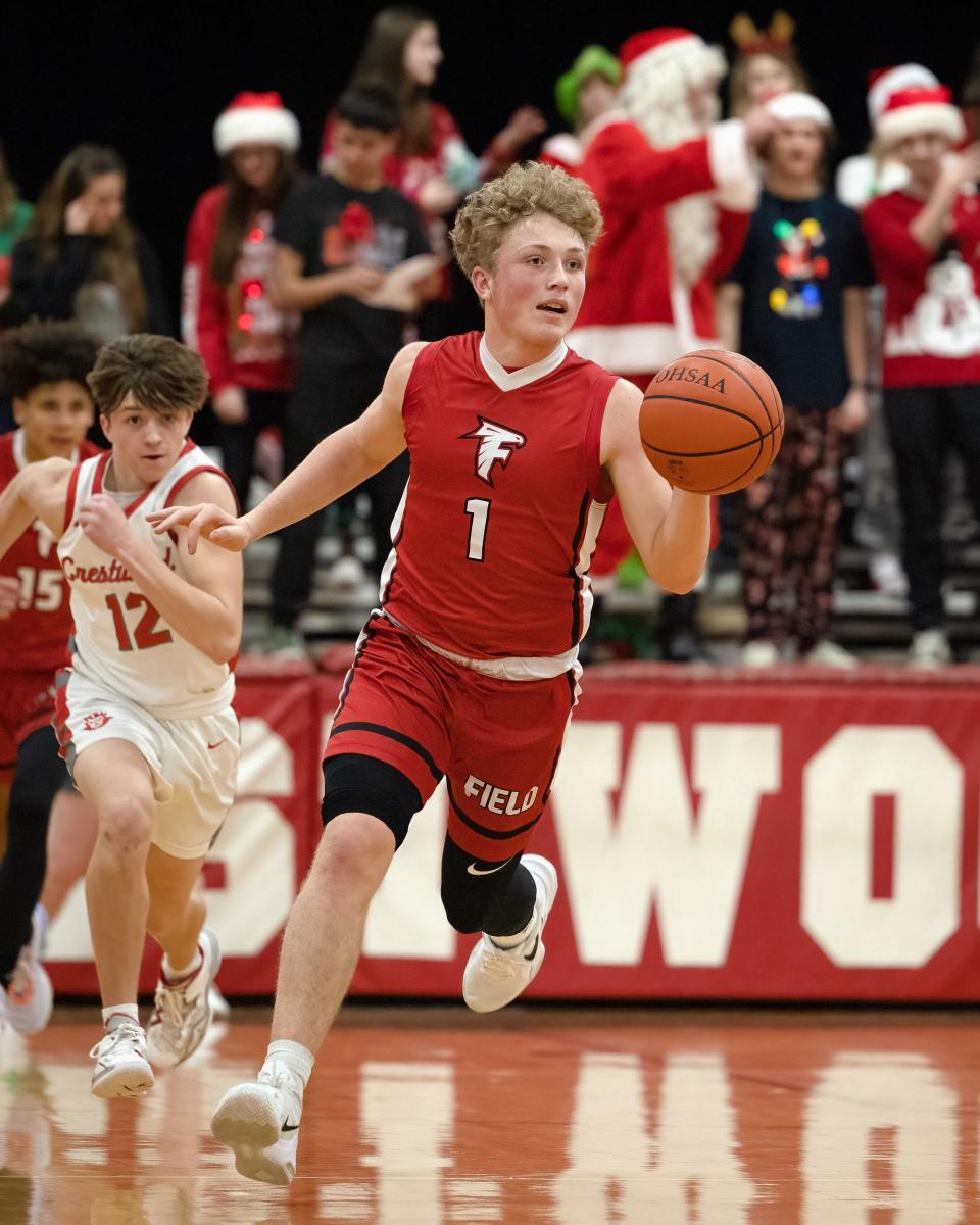 Field senior Braxton Baumberger brings the ball up the court during Monday night’s basketball game at Crestwood High School.
