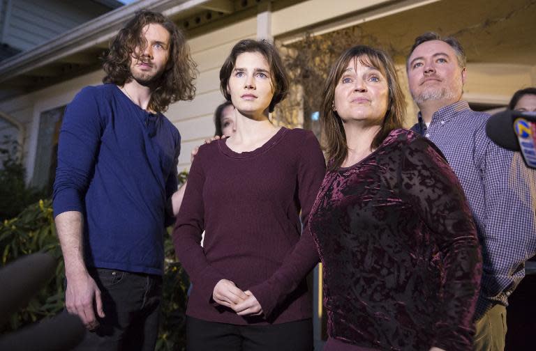 Amanda Knox (C) speaks to the media during a brief press conference in front of her parents' home March 27, 2015 in Seattle, Washington