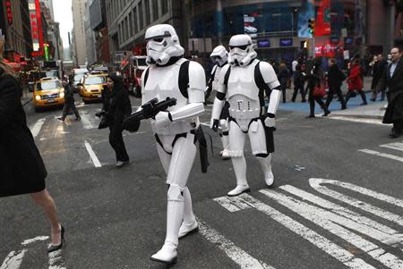 Star Wars Storm Trooper characters cross the street outside the NASDAQ Market Site in New York's Times Square after taking part in ringing the opening bell for the trading day, December 20, 2011. REUTERS/Mike Segar