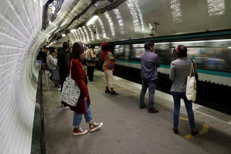 Commuters wait to board a metro at the Gare du Nord subway station during a strike by all unions of the Paris transport network (RATP) against pension reform plans in Paris