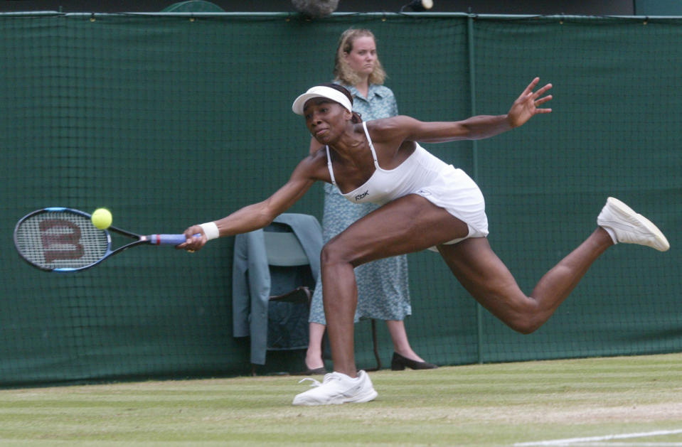 FILE - In this July 6, 2002, file photo, Venus Williams stretches for a shot from her sister Serena during the women's singles final on the Centre Court at Wimbledon. Serena won the match 7-6 (7-4), 6-3 to win the championship. (AP Photo/Dave Caulkin, File)