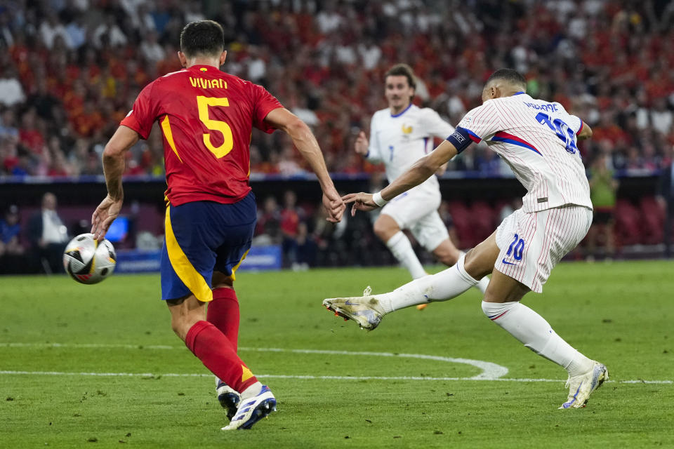 Kylian Mbappe of France, right, shoots during a semifinal match between Spain and France at the Euro 2024 soccer tournament in Munich, Germany, Tuesday, July 9, 2024. (AP Photo/Antonio Calanni)