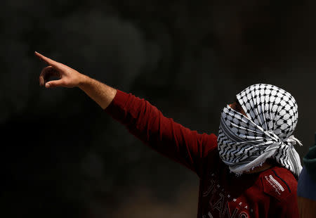 A Palestinian protester gestures during clashes with Israeli troops near the Jewish settlement of Beit El, in the Israeli-occupied West Bank March 20, 2019. REUTERS/Mohamad Torokman