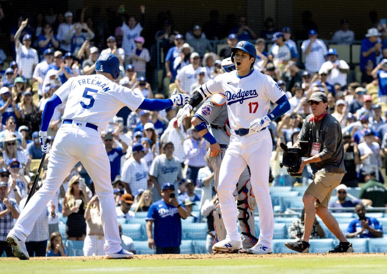 Shohei Ohtani, right, is congratulated by Freddie Freeman after hitting a two-run home run.