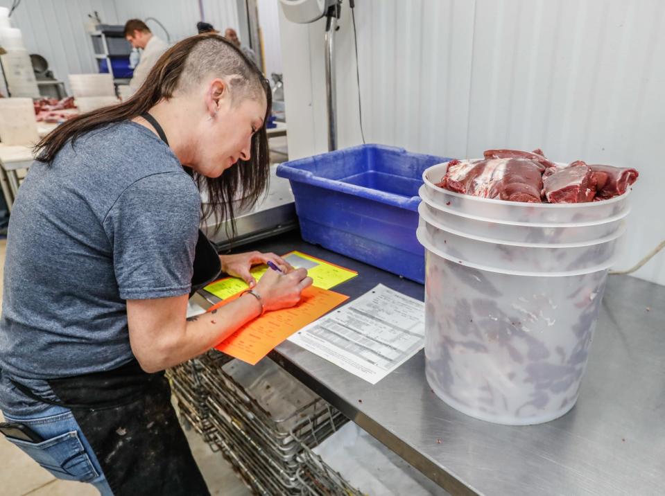 Fund Development Director of Hoosiers Feeding the Hungry, Amber Zecca, processes deer meat on Thursday, Nov. 4, 2021, at D&D Meat Processing in Corunna Indiana. Here hunters can donate legally harvested deer meat to the hungry through a partnership between Hoosiers Feeding the Hungry and the DNR's Sportsmen Benevolence Fund.