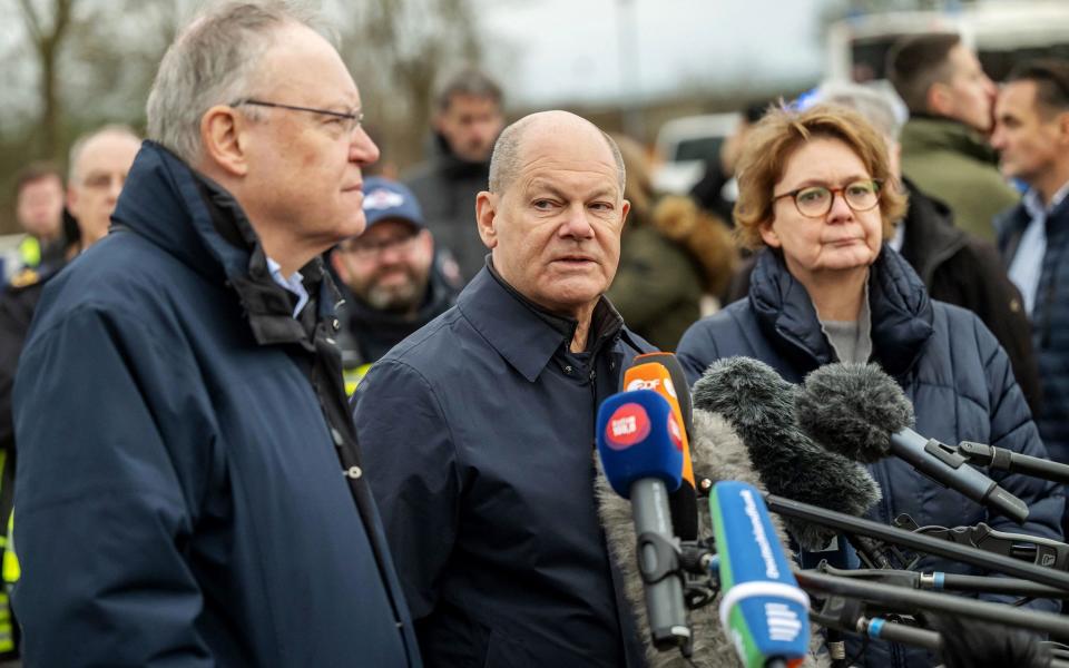 Lower Saxony's State Premier Stephan Weil, German Chancellor Olaf Scholz and Lower Saxony's Interior Minister Daniela Behrens address journalists in Verden on December 31 during a visit to the flood-stricken areas of Lower Saxony