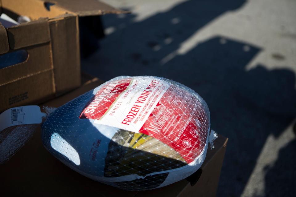 Volunteers hand out turkeys at Kingswood Community Center Friday, Nov. 19, 2021.