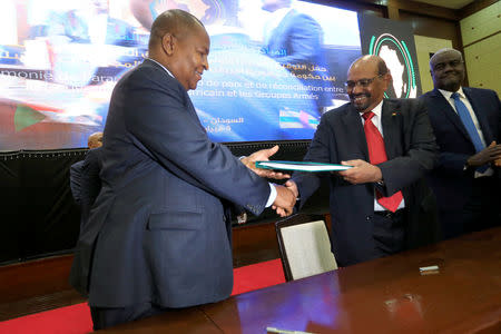 Central African Republic President Faustin-Archange Touadera and Sudan's President Omar al-Bashir are seen after signing a peace deal between the Central African Republic government and 14 armed groups following two weeks of talks in the Sudanese capital Khartoum, Sudan, February 5, 2019. REUTERS/Mohamed Nureldin Abdallah