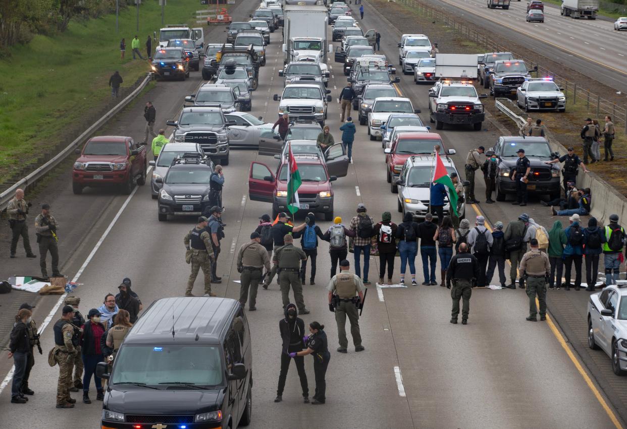 Dozens of protesters were arrested Monday as they blocked the southbound lanes of Interstate 5 under the Harlow overpass between Eugene and Springfield.