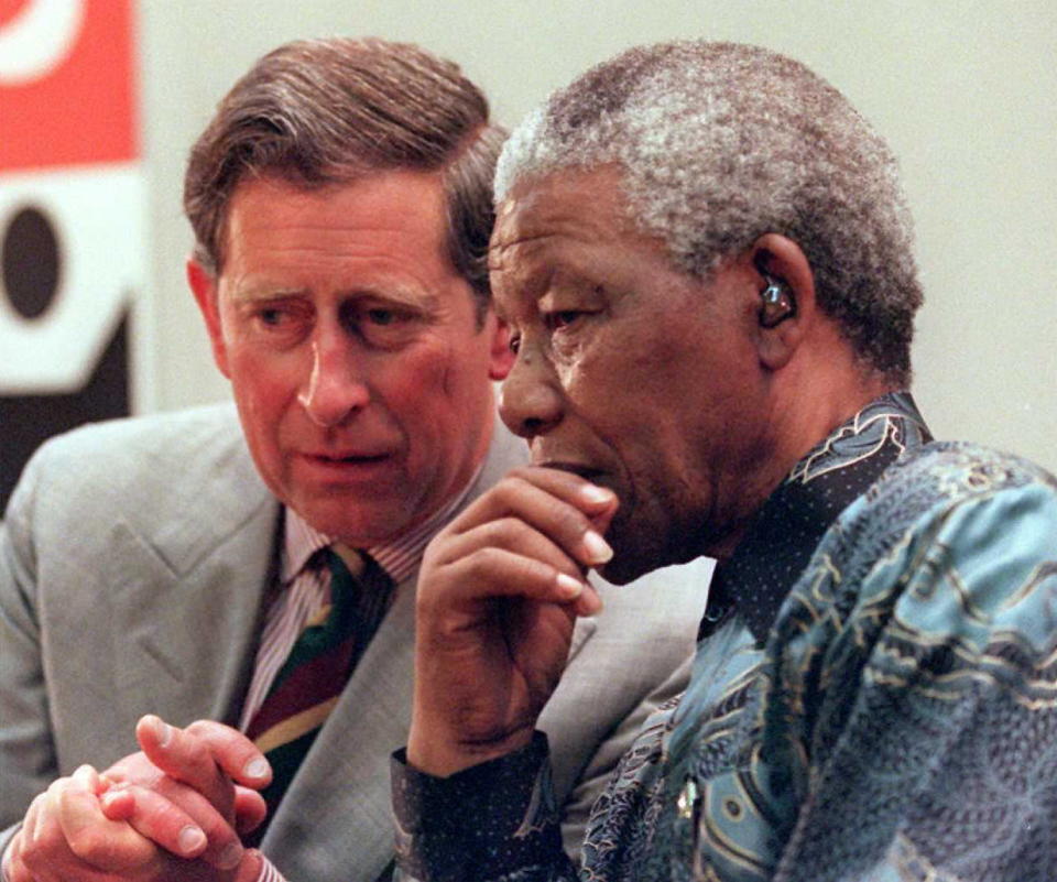 LONDON, UNITED KINGDOM - JULY 12:  South African President Nelson Mandela(R) talks with Prince Charles(L) 12 July in Brixton, south London, on the last day of Mandela's four-day state visit to the United Kingdom. Media reports in Britain said Prince Charles' wife, Princess Diana, had accepted divorce terms last week, but that Buckingham Palace wanted to wait until Mandela finished his visit before making an announcement.  AFP PHOTO  (Photo credit should read DAVID THOMSON/AFP via Getty Images)
