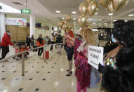 Passengers from New Zealand are welcomed by drag queens as they arrive at Sydney Airport in Sydney, Australia, Monday, April 19, 2021, as the much-anticipated travel bubble between Australia and New Zealand opens. (AP Photo/Rick Rycroft)