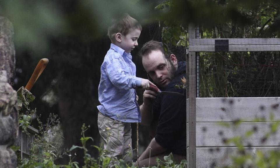 Joshua Boyle and his son Jonah play in the garden in Smiths Falls on Saturday.