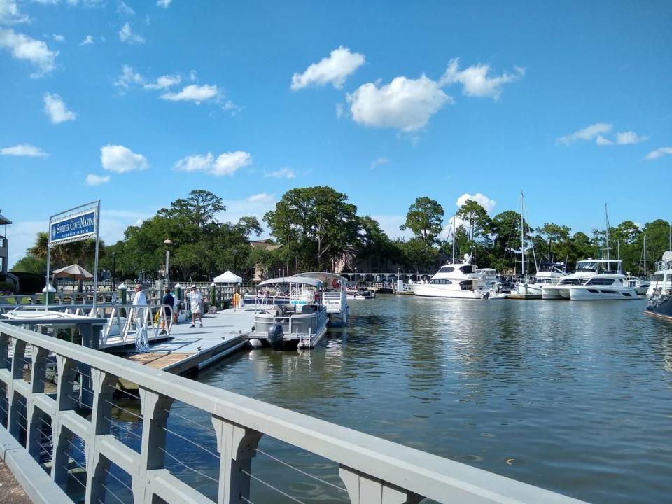 Visitors from as far away as New York and Ohio wait for rental boats at Shelter Cove Marina on Wednesday, July 1, 2020. Tourists said the extent of the pandemic in their home states has shaped how they are experiencing their July 4th vacation.